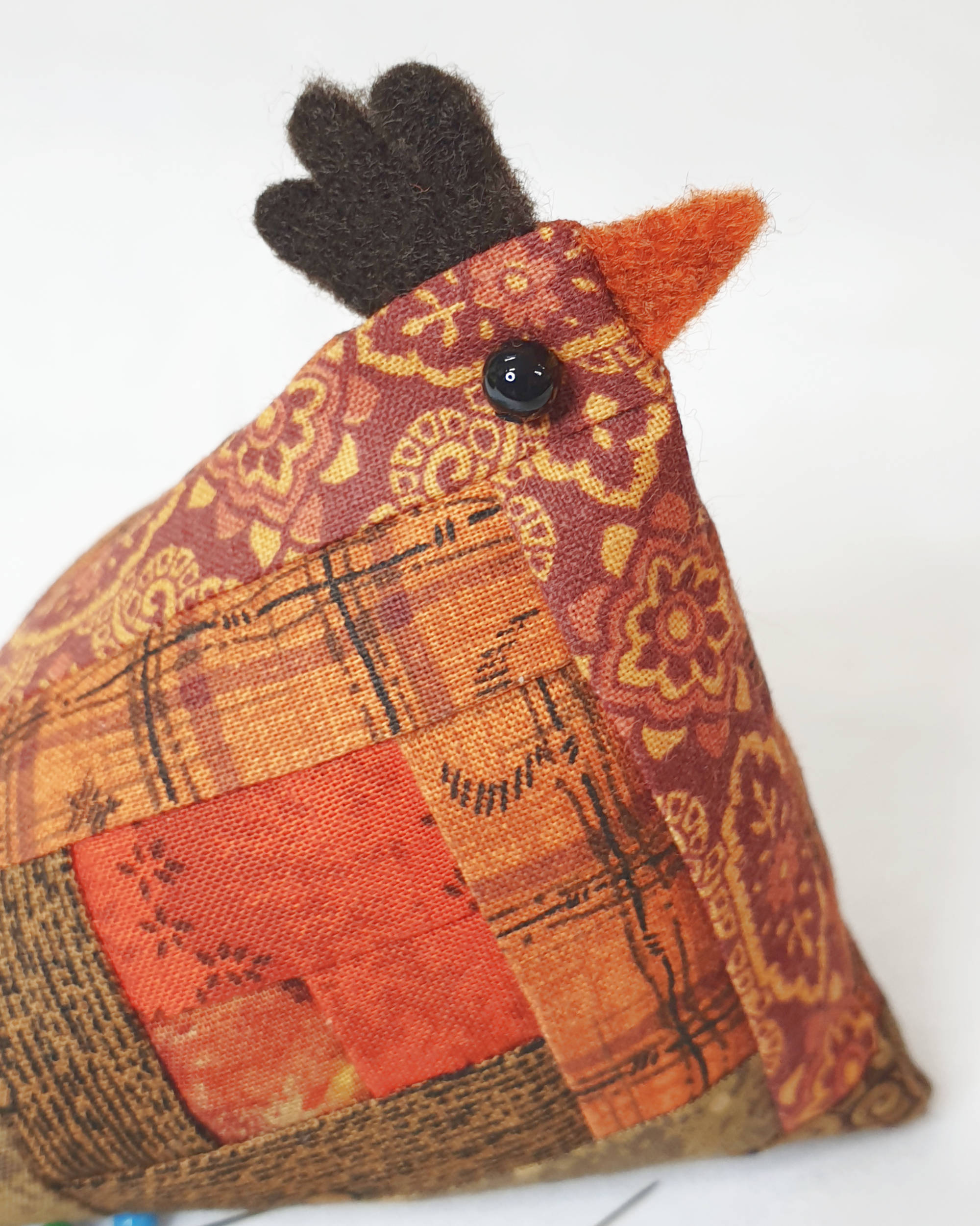 Orange and brown chicken pin cushion - Closeup of face