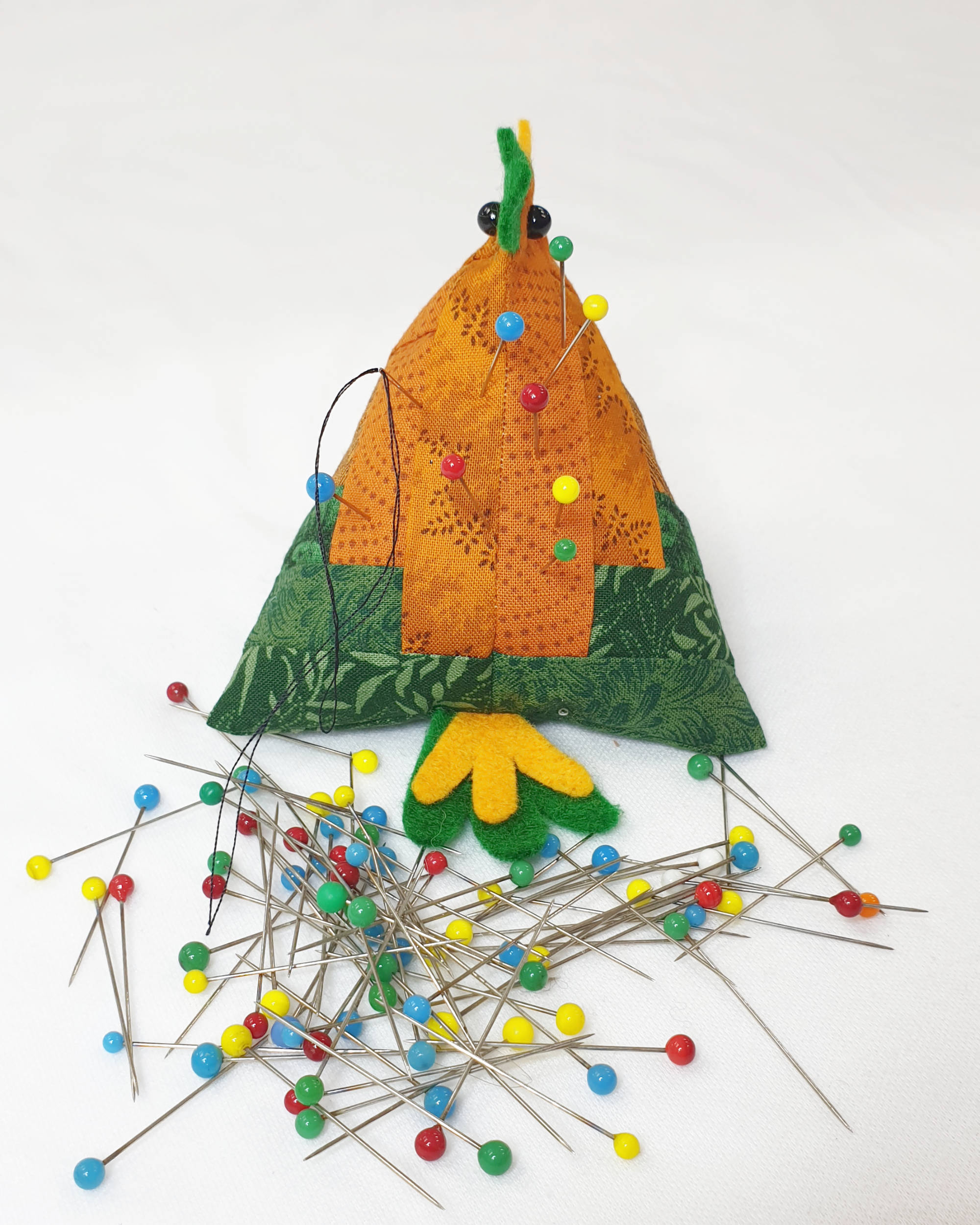 Orange and green chicken pin cushion - Rear view showing title