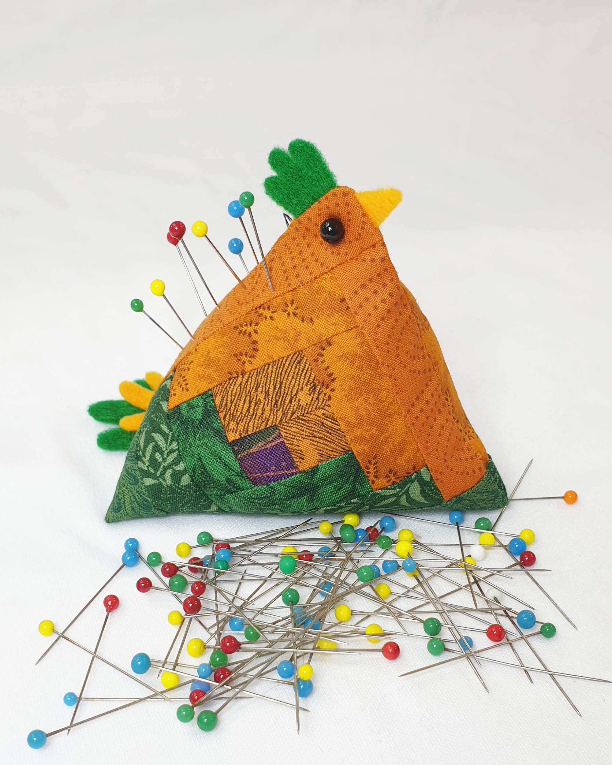 Orange and green chicken pin cushion - Facing right