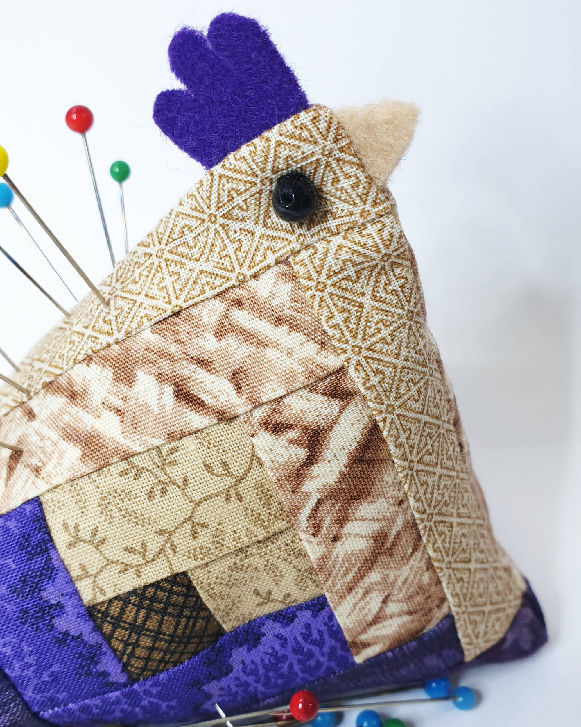 Tan and purple chicken pin cushion - Closeup of face
